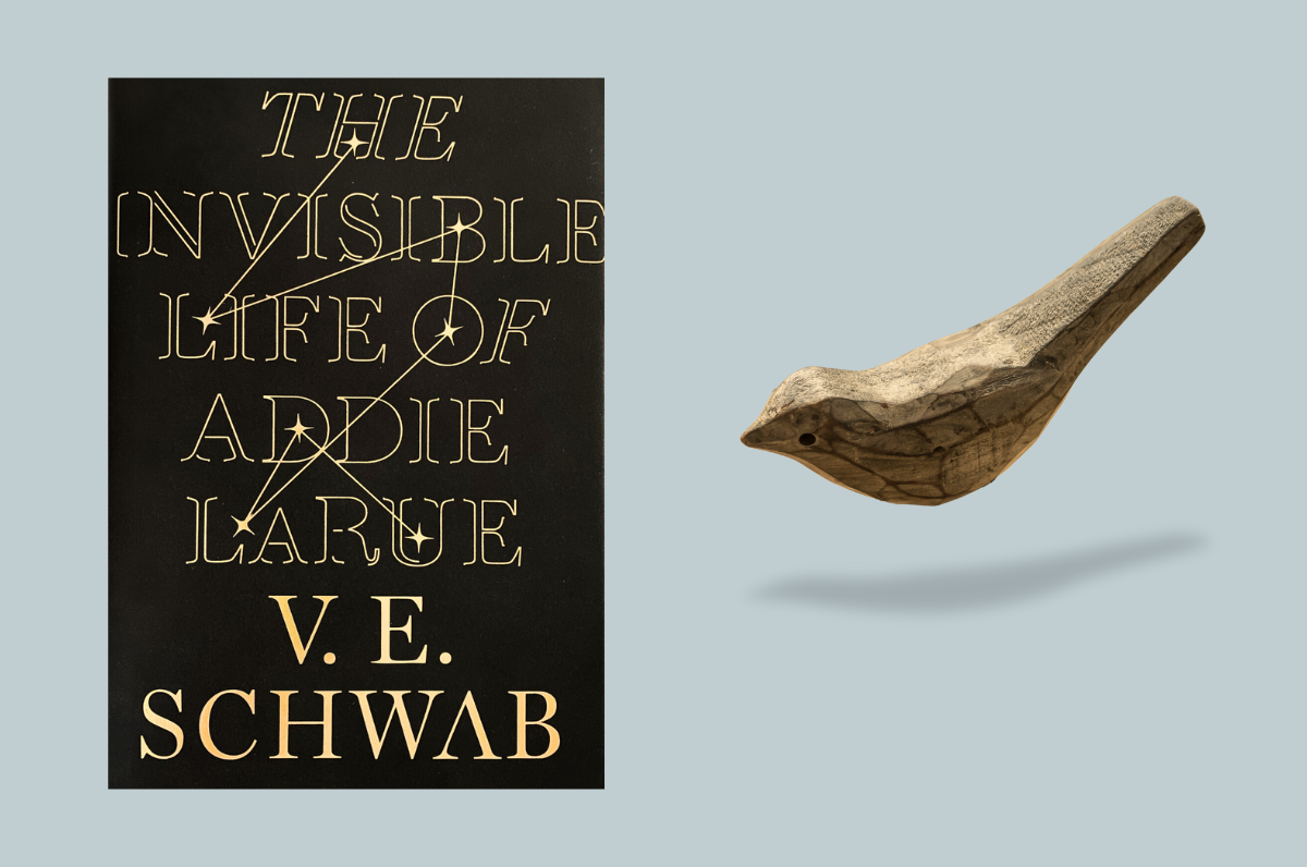 Image of cover of The Invisible Life of Addie Larue with a wooden bird to the right